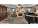 Elegant living room featuring a fireplace, piano, and tasteful decor for a cozy ambiance at 2132 Palm Vista Dr, Apopka, FL 32712