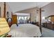 Airy main bedroom boasts vaulted ceilings, a four-poster bed, and a large dresser at 2132 Palm Vista Dr, Apopka, FL 32712