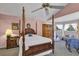 Vaulted main bedroom features a four-poster bed, cozy window seat and ample closet space at 2132 Palm Vista Dr, Apopka, FL 32712