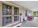 Inviting porch with doors to the main house, a table, chairs, and peaceful outdoor views at 2132 Palm Vista Dr, Apopka, FL 32712