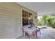 Welcoming porch area with seating, table, and scenic outdoor views at 2132 Palm Vista Dr, Apopka, FL 32712