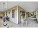 Spacious outdoor porch with seating and views of the surrounding nature at 2132 Palm Vista Dr, Apopka, FL 32712