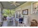 Enclosed porch with furniture for relaxing, featuring a ceiling fan, and beautiful views of nature at 2132 Palm Vista Dr, Apopka, FL 32712