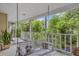 Inviting porch features a swing, decorative pillows, and a view of lush greenery at 2132 Palm Vista Dr, Apopka, FL 32712