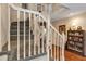 Carpeted staircase with white banister and hardwood floors in the house at 2132 Palm Vista Dr, Apopka, FL 32712