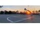Lit outdoor basketball court, perfect for evening games and recreational activities at sunset at 2305 Rio Grande Forest Ln, Kissimmee, FL 34759
