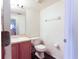 Modest bathroom featuring single sink vanity, mirror, toilet, and tile floors at 2305 Rio Grande Forest Ln, Kissimmee, FL 34759