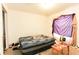 A bedroom with a queen bed, side table, and personal items spread throughout the room at 2305 Rio Grande Forest Ln, Kissimmee, FL 34759