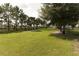 Lush dog park featuring green grass, shade trees, and a picnic shelter for community enjoyment at 2305 Rio Grande Forest Ln, Kissimmee, FL 34759