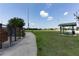 Scenic dog park entrance with clear signage and a view of picnic tables on a manicured lawn at 2305 Rio Grande Forest Ln, Kissimmee, FL 34759