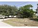 Exterior shot of house with mature trees; showcases the two-car garage, front lawn, and overall curb appeal at 2305 Rio Grande Forest Ln, Kissimmee, FL 34759