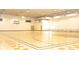 Full gymnasium featuring basketball court, exercise equipment, and bleachers at 2305 Rio Grande Forest Ln, Kissimmee, FL 34759