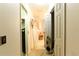 Hallway with doors opening to other rooms in the home, light walls and flooring at 2305 Rio Grande Forest Ln, Kissimmee, FL 34759