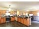 Functional kitchen design with wood cabinets, stainless steel appliances, and wood floors extending throughout the kitchen at 2305 Rio Grande Forest Ln, Kissimmee, FL 34759