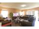 Cozy living room featuring wood-look floors, a large window, and ample seating at 2305 Rio Grande Forest Ln, Kissimmee, FL 34759