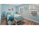 Comfortable bedroom with a beach-themed decor, wood floors, and natural light from the windows at 240 Cambridge Blvd, Winter Park, FL 32789