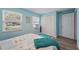 Blue bedroom featuring wood-look flooring, closet, and bright light from two windows at 240 Cambridge Blvd, Winter Park, FL 32789