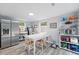 Well-lit dining area with stainless steel refrigerator and ample shelving at 240 Cambridge Blvd, Winter Park, FL 32789