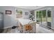 Sunlit dining area with a white table, wood chairs, and sliding glass door to the outside at 240 Cambridge Blvd, Winter Park, FL 32789