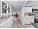 Hallway view showcasing ample cabinet space and an open floor plan leading to the kitchen and living areas at 240 Cambridge Blvd, Winter Park, FL 32789