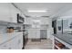 Modern kitchen featuring white cabinets, stainless steel appliances, and sleek countertops, perfect for cooking at 240 Cambridge Blvd, Winter Park, FL 32789