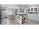 Bright kitchen featuring an island, stainless steel appliances, and an adjacent dining area at 240 Cambridge Blvd, Winter Park, FL 32789