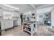 Bright kitchen with stainless steel appliances, and an island prep area; seamlessly flows into the dining area at 240 Cambridge Blvd, Winter Park, FL 32789