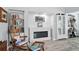 Cozy living room with a charming fireplace, built-in bookshelves, and a rocking chair for a relaxing ambiance at 240 Cambridge Blvd, Winter Park, FL 32789