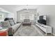 Bright living room features neutral decor, two sofas, two windows, and a modern entertainment center at 240 Cambridge Blvd, Winter Park, FL 32789