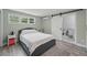 Cozy bedroom with light green walls, barn-style door, and ensuite bathroom access at 240 Cambridge Blvd, Winter Park, FL 32789
