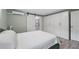 Bedroom featuring white wardrobe closets, barn-style door, and wood-look floors at 240 Cambridge Blvd, Winter Park, FL 32789
