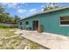 View of the backyard with concrete patio and sliding glass doors to access backyard at 240 W Grossenbacher Dr, Apopka, FL 32712