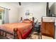 Well-lit bedroom featuring wood bed, wall art, and a ceiling fan, offering a blend of comfort and style at 240 W Grossenbacher Dr, Apopka, FL 32712