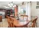 Cozy dining area featuring wood table, decorative centerpiece, chandelier lighting, and sliding glass window views at 240 W Grossenbacher Dr, Apopka, FL 32712