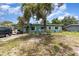 Charming single-story home with a covered carport, front yard, and mature tree at 240 W Grossenbacher Dr, Apopka, FL 32712