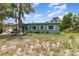 Charming single-story home with a covered carport, front yard, and mature tree at 240 W Grossenbacher Dr, Apopka, FL 32712
