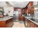 Spacious kitchen featuring stainless steel appliances, custom cabinetry, granite countertops, and an open layout at 240 W Grossenbacher Dr, Apopka, FL 32712
