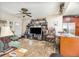 Open-concept living room and kitchen with tile floors, kitchen counter seating, and ceiling fan at 240 W Grossenbacher Dr, Apopka, FL 32712
