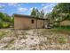 View of a shed in a spacious backyard, with a small window and double door at 240 W Grossenbacher Dr, Apopka, FL 32712