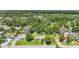 This aerial shot displays a community with verdant trees, showcasing a residence and the surrounding homes in the neighborhood at 2704 Yule Tree Dr, Edgewater, FL 32141
