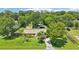 Aerial view of a single-Gathering home with spacious yard, mature trees, and additional storage shed on the property at 2704 Yule Tree Dr, Edgewater, FL 32141