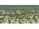 An aerial view showcases a neighborhood with lush tree coverage and a single-Gathering home centered among the residences at 2704 Yule Tree Dr, Edgewater, FL 32141