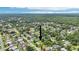 Aerial view of a home in a quiet neighborhood surrounded by lush greenery at 2704 Yule Tree Dr, Edgewater, FL 32141