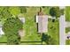 Overhead view of a well-maintained property with a large backyard, mature trees, and a shed or outbuilding at 2704 Yule Tree Dr, Edgewater, FL 32141