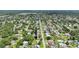 Overhead view of a home situated in a vibrant neighborhood surrounded by lush green trees at 2704 Yule Tree Dr, Edgewater, FL 32141