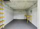 Unfinished basement with concrete floor, workbench, and ladder at 2704 Yule Tree Dr, Edgewater, FL 32141