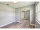 This bedroom features new wood floors, ceiling fan, gray walls, and a large mirrored closet at 2704 Yule Tree Dr, Edgewater, FL 32141