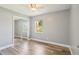 A bright bedroom features new wood floors, gray walls, ceiling fan, and large mirrored closet at 2704 Yule Tree Dr, Edgewater, FL 32141