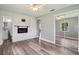 A spacious bedroom with wood flooring, mirrored closet doors, and an electric fireplace at 2704 Yule Tree Dr, Edgewater, FL 32141