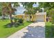 Charming home with a lush lawn, mature trees, and attached garage at 2704 Yule Tree Dr, Edgewater, FL 32141
